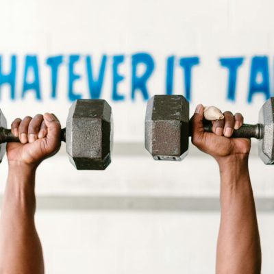 A person's hands in a strong grip position during a workout.