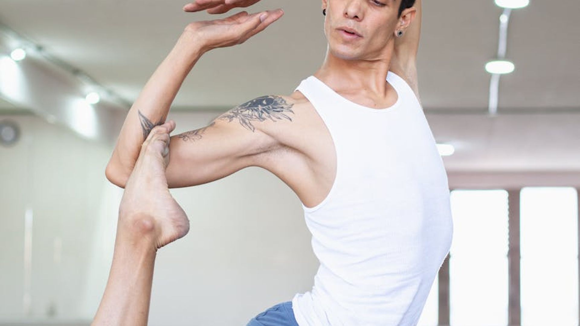 Man performing a controlled strength exercise in a minimalist setting.